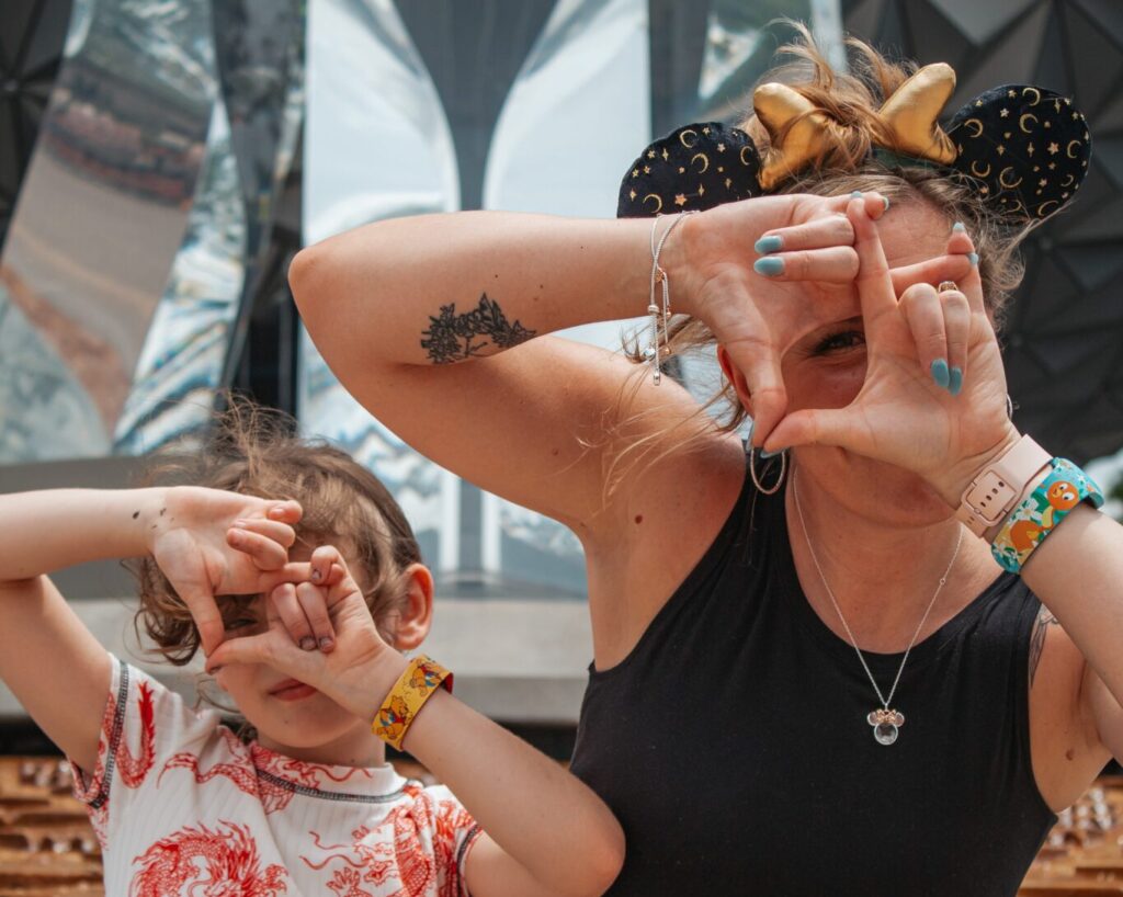 Photo of Heather Sparklestar, travel advisor with her daughter at Epcot Spaceship Earth. Photo taken by Jade Alexander photography.