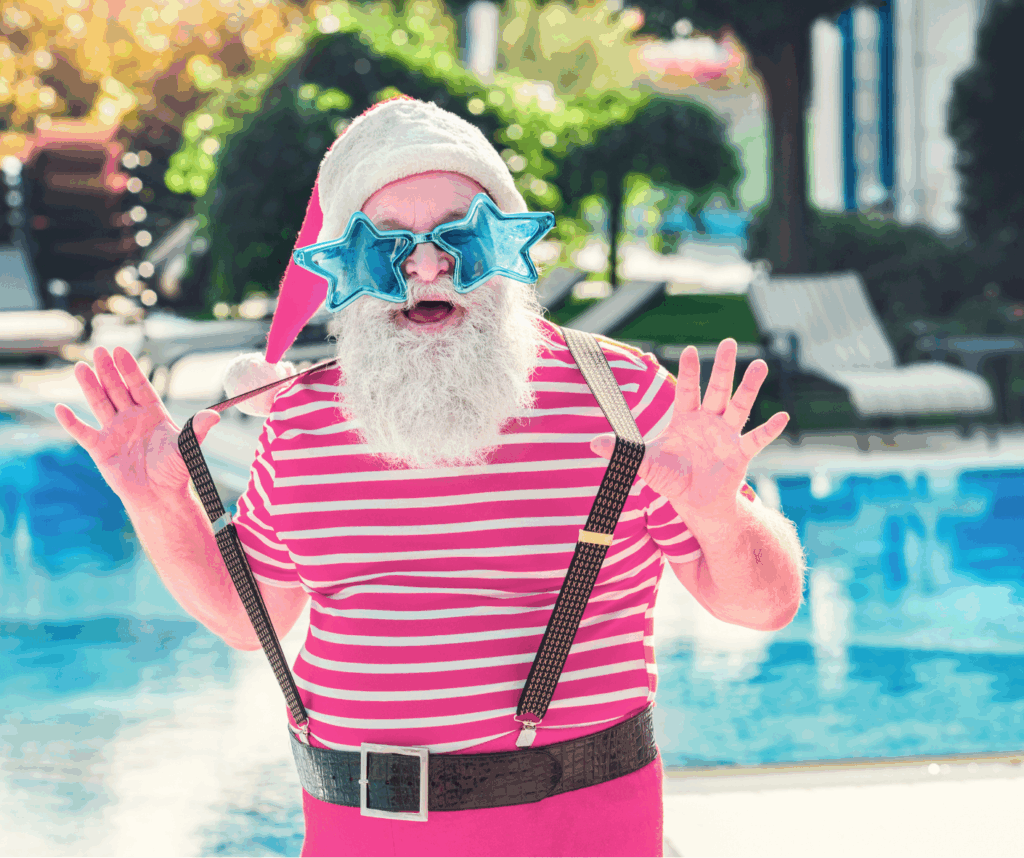 Santa Claus by pool with star sunglasses on to accompany a blog by Heather Sparklestar, travel advisor, regarding best Christmas vacations for families.